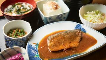A variety of dishes including a fish in sauce, tofu, and other side dishes.