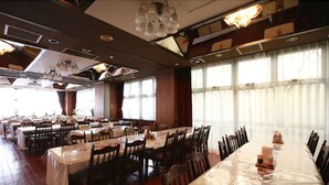 A large dining hall with multiple tables and chairs, arranged in a spacious layout. - Hotel Select Inn Utsunomiya (Utsunomiya)