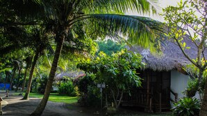 A thatched-roof hut with a sign indicating it is a 'Cottage'. - Hijo Resorts Davao (Tagum)