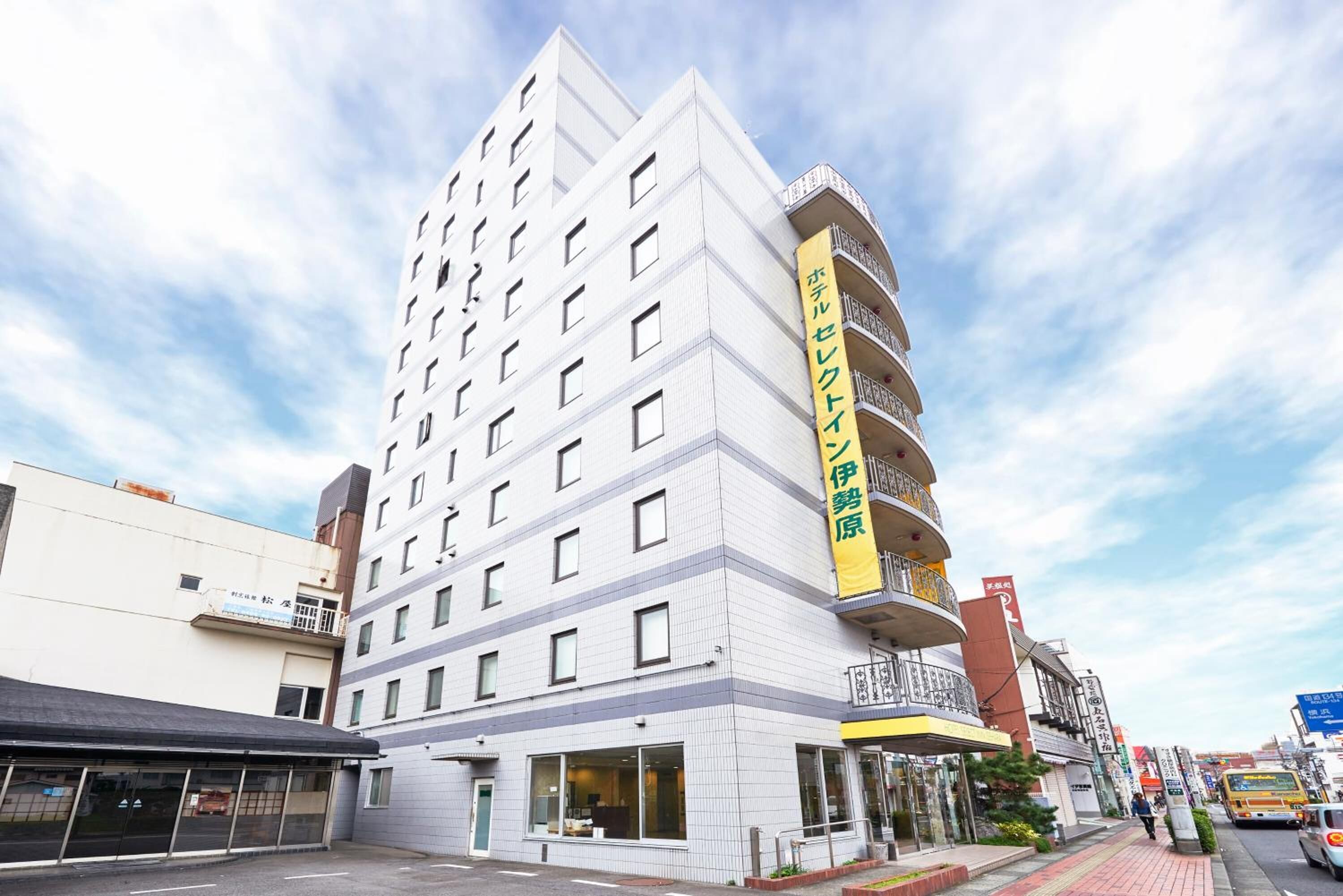 A multi-story hotel with a prominent yellow sign on the side.