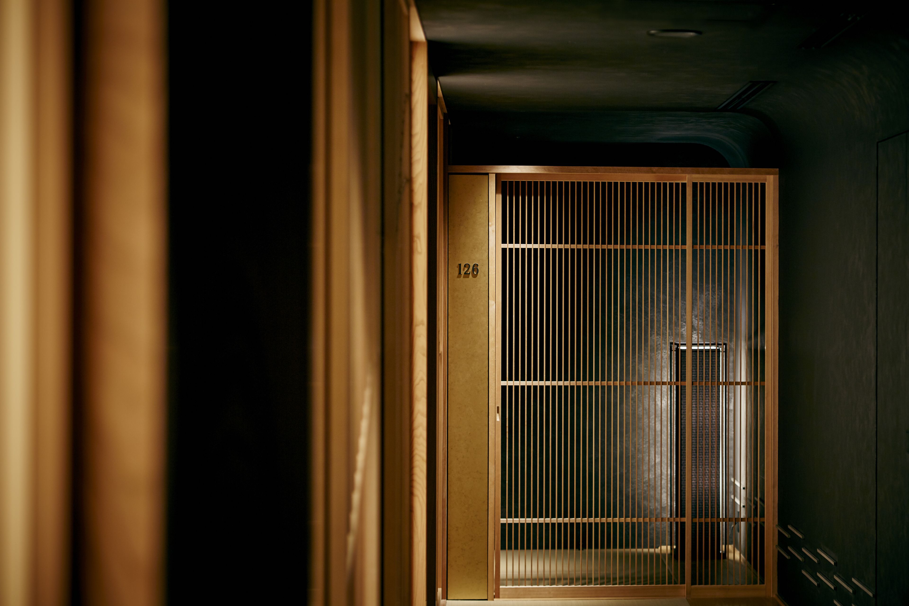 A traditional Japanese room with a sliding door marked with the number 126.