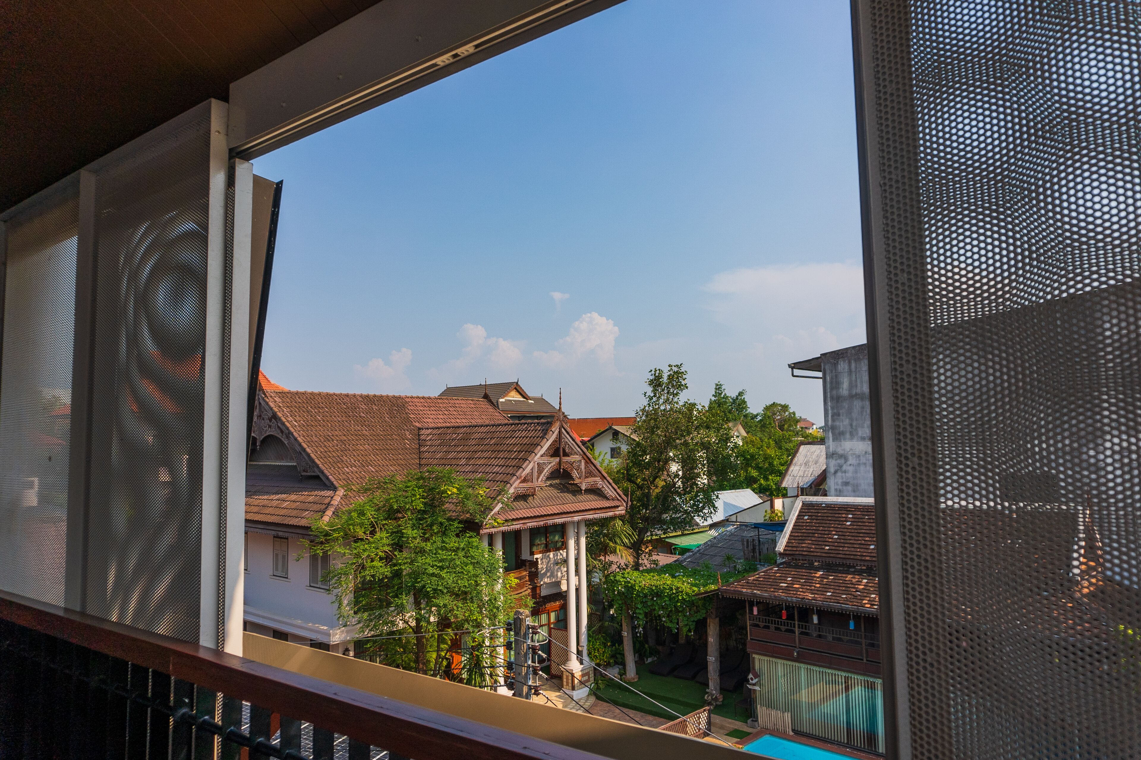 A view of traditional houses with tiled roofs and a clear sky.