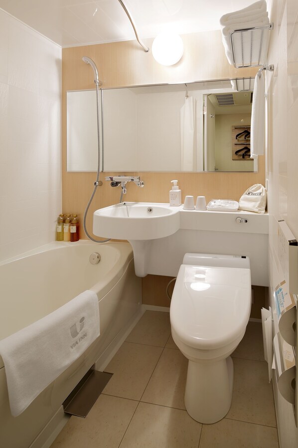 A modern bathroom with a bathtub, sink, and toilet.