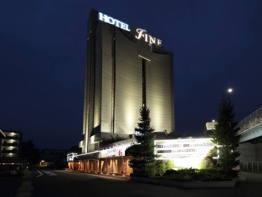 A tall hotel building with a prominent sign reading "HOTEL FINE".