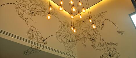 Un interior moderno con un diseño de pared geométrico y lámparas colgantes.