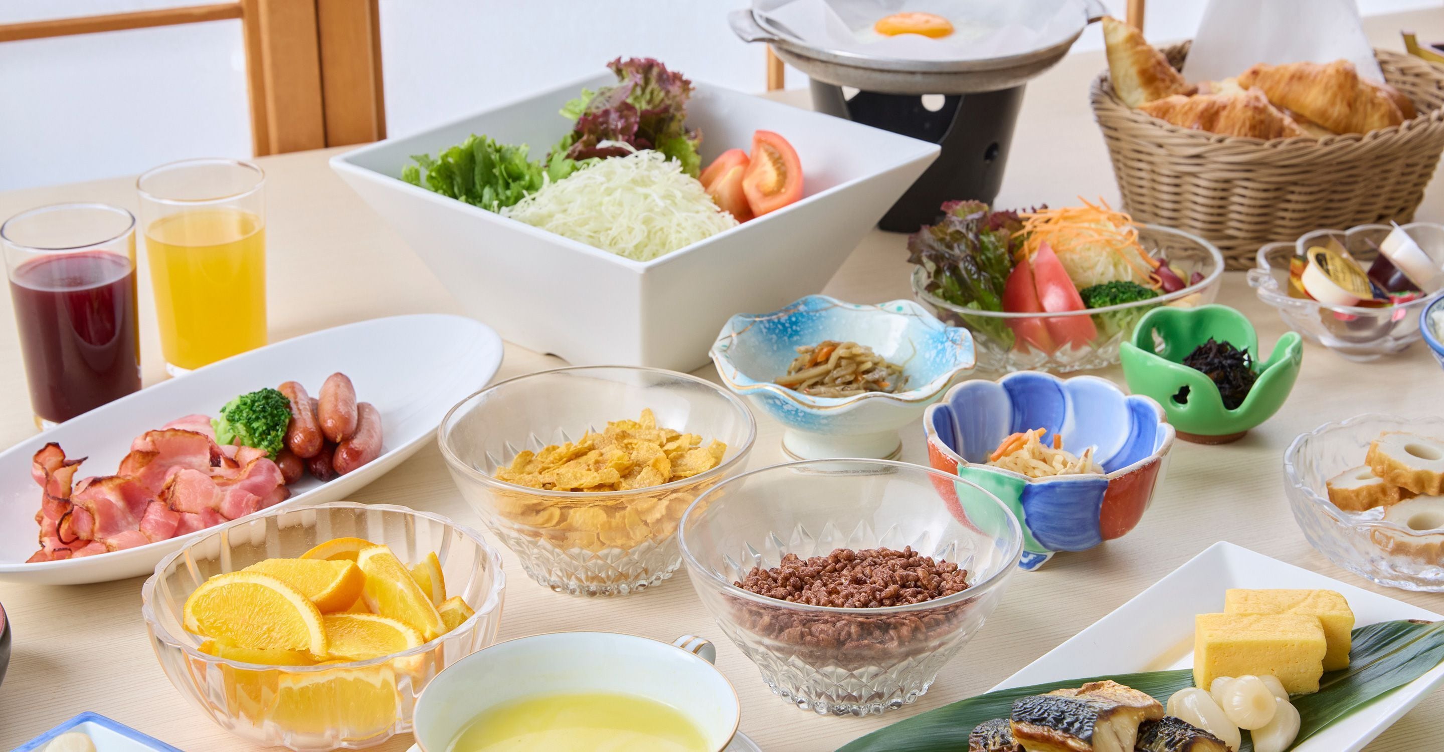 A table with various food items, including fruits, vegetables, and dishes, suggesting a meal setting.