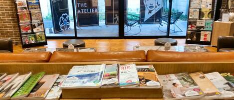 A bookstore with leather seating and a variety of magazines and books on display.