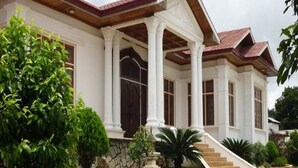 A two-story house with a covered porch, columns, and a stone foundation. - Hsaung Thazin Hotel Nay Pyi Taw (Oattara Thiri Township)