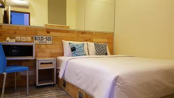 A hotel room with a bed, a desk, and a chair. There is a sign on the wall that reads "BOLD-505 HOTEL".
