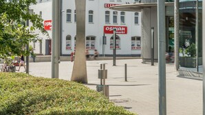 A modern building with a unique architectural design, featuring a prominent sculpture in the foreground and a clear view of the surrounding area. - City Hotel Wetzlar (Wetzlar)