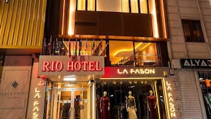 Un hotel con fachada moderna, varios pisos y ventanas iluminadas.