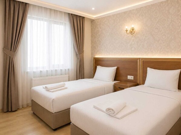 A hotel room with two beds, a nightstand, a wall-mounted light fixture, and a window with curtains. - Hotel Rio (Istanbul)