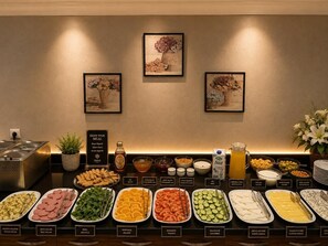 A buffet with various food items and a sign that says 'ENJOY YOUR MEAL.'