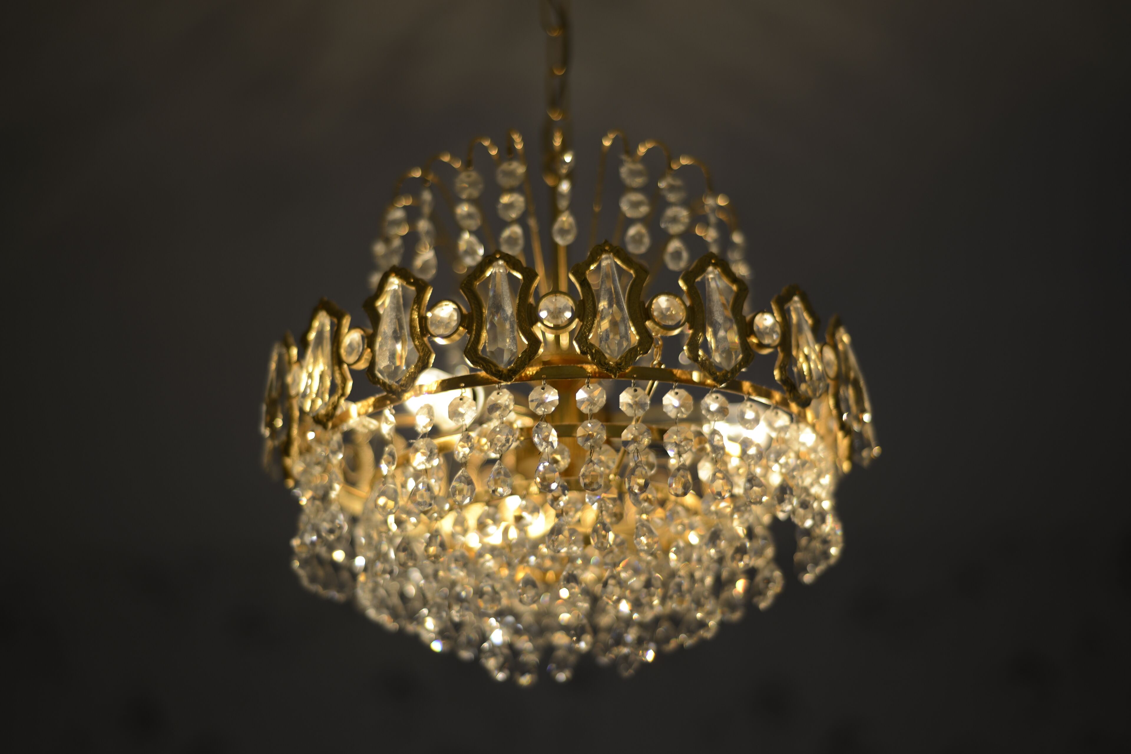 A chandelier with a crystal crown design.