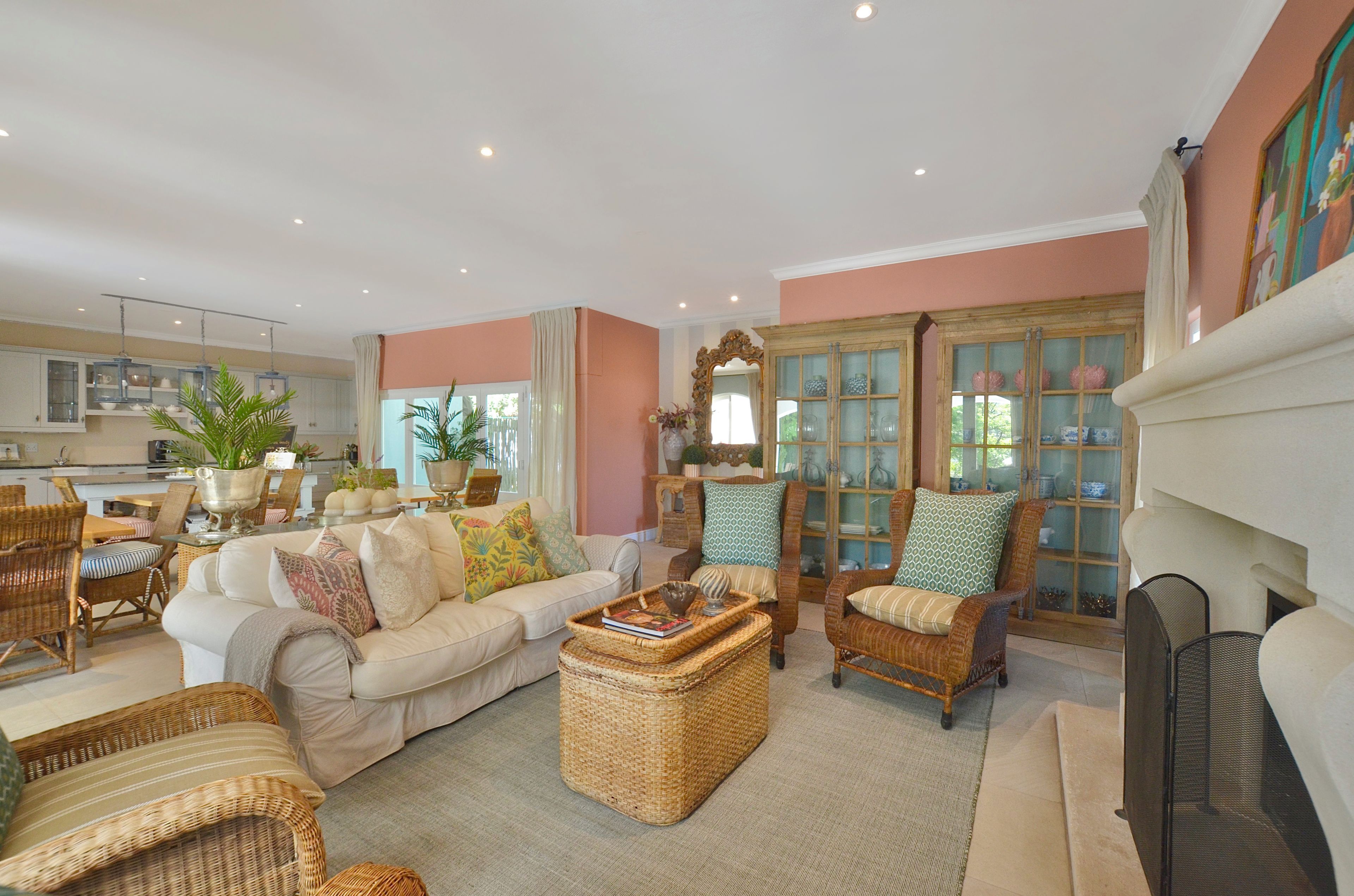 A spacious living room with a sofa, chairs, a coffee table, and a fireplace.