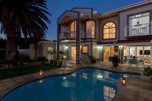 A two-story house with a swimming pool, outdoor seating, and a balcony. - Atlantic Beach Villa (Cape Town)