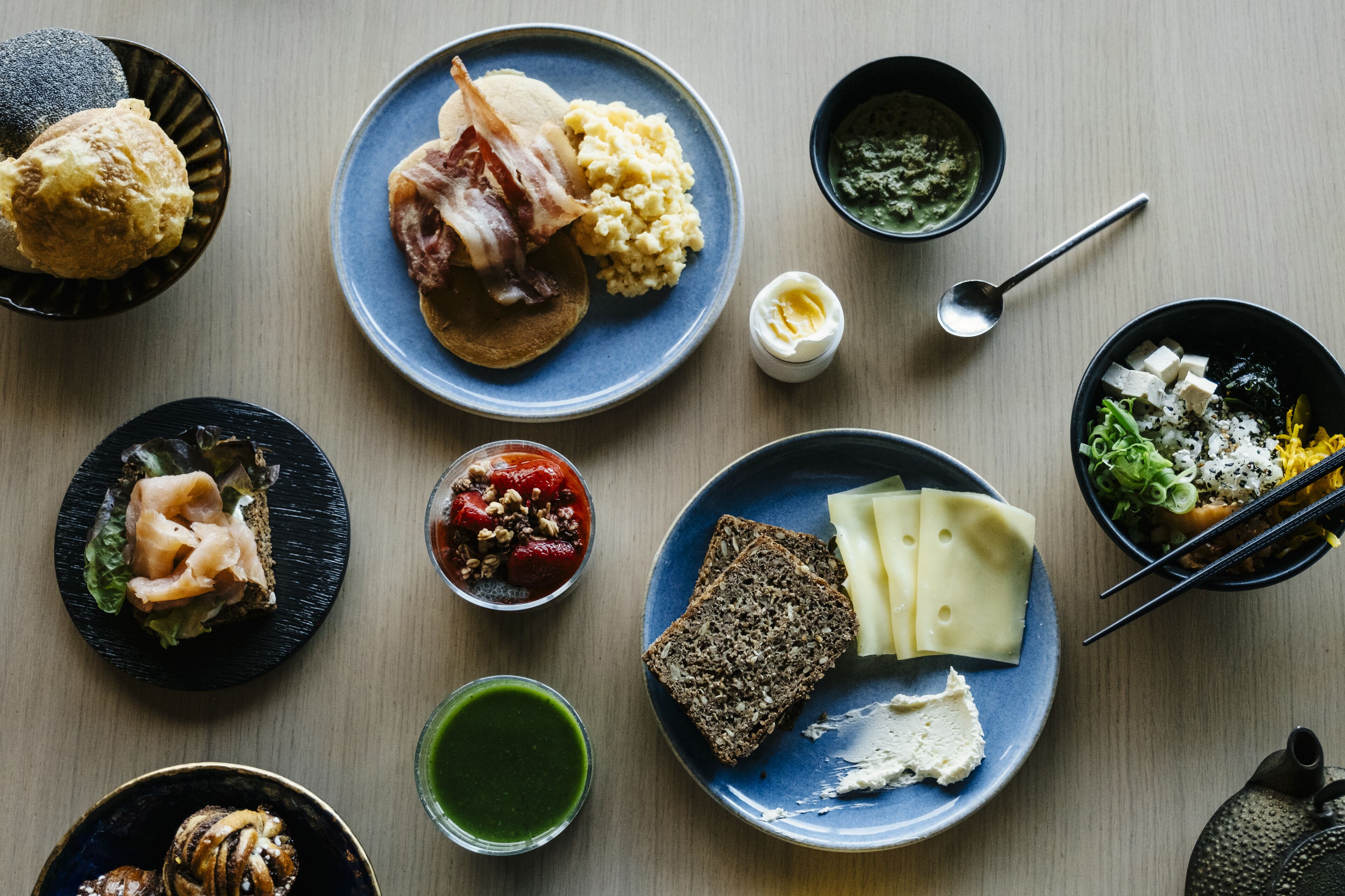 A variety of dishes on plates, including a sandwich, mashed potatoes, and a bowl of soup.