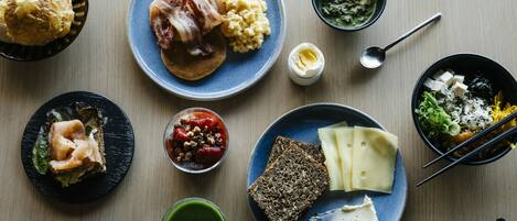 A variety of dishes on plates, including a sandwich, mashed potatoes, and a bowl of soup.
