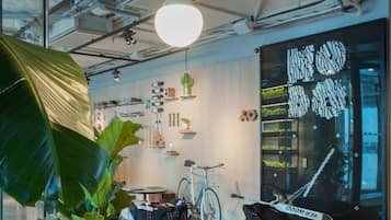 A modern interior with a leather sofa, a wicker table, and a bicycle.