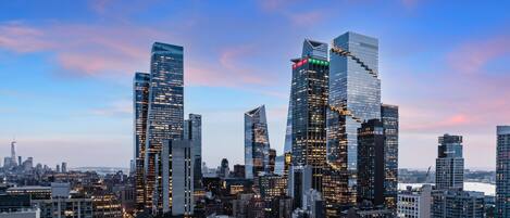 A cityscape with modern skyscrapers, a river, and a clear sky.