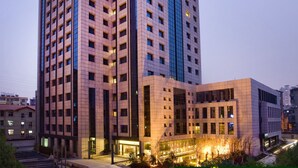 A high-rise building with multiple floors, large windows, and a well-lit entrance area. - Narada Boutique hotel Nanchang Red Bull (Nanchang)