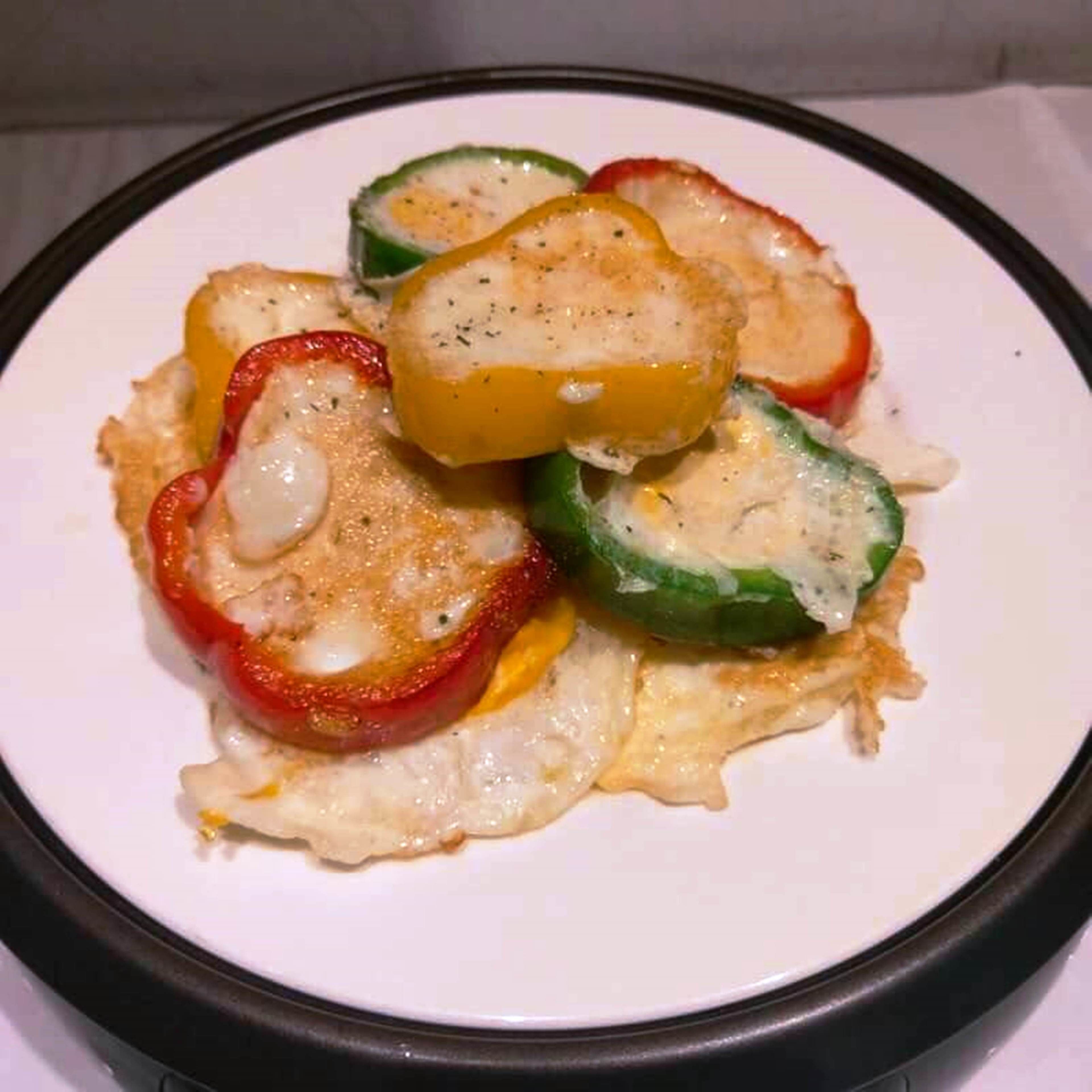 A plate of food with sliced bell peppers and a yellow fruit.
