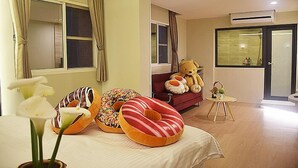 Ein Hotelzimmer mit einem Bett, einem Teddybären und einem Fenster mit Vorhängen.