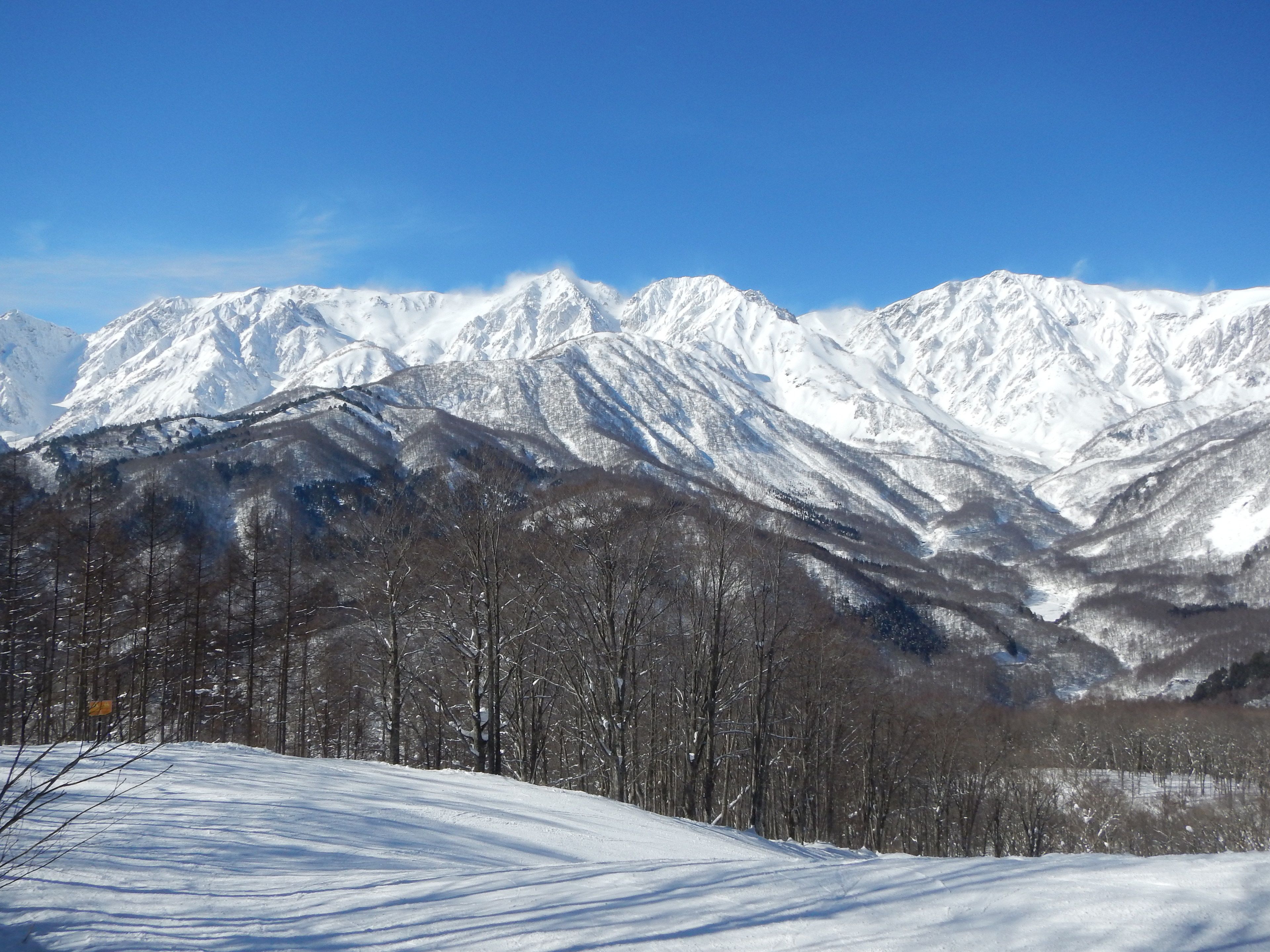A snow-covered mountain range with clear skies.
