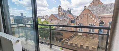 Un balcón con vistas a edificios históricos y un cielo despejado.