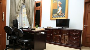 A room with a desk, two office chairs, a computer, a television, and a cabinet. - Puri Kusuma Guest House (Tabanan)