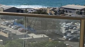 A view from a high-rise building overlooking a parking lot and the sea. - Beach View Apartments And Studio (Tel Aviv)