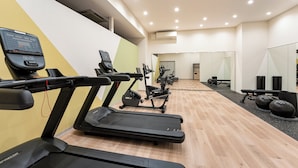 A gym with treadmills, exercise bikes, and free weights. - ANA Holiday Inn Tosu by IHG   (Tosu)