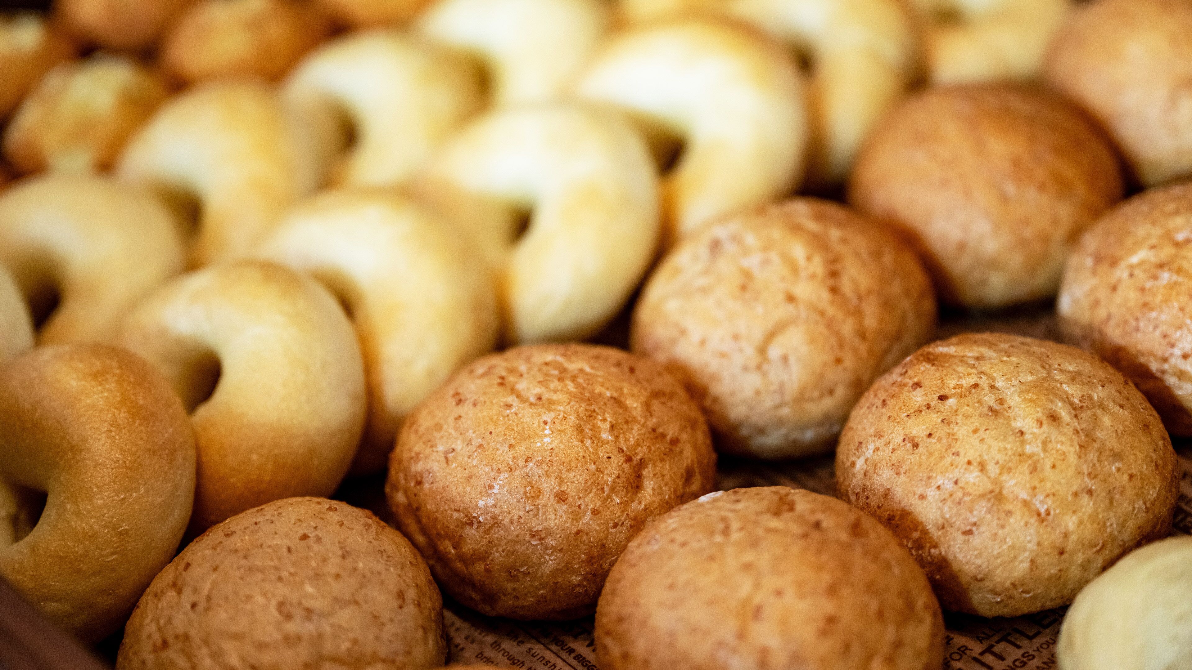 A variety of round, textured bread rolls.