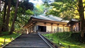 A traditional Japanese building with a wooden structure, a tiled roof, and a stone staircase leading up to it. - ANA Holiday Inn Iwate Kitakami by IHG (Kitakami)