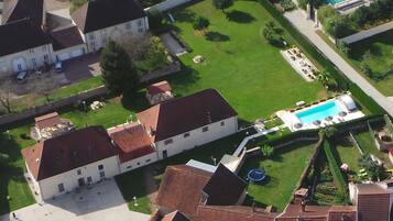 Stunning historic complex with a central courtyard, swimming pool, and manicured lawns.