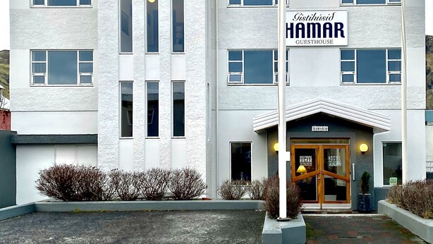 A modern building with a sign reading "Gästhaus HAMAR". - Guesthouse Hamar (Vestmannaeyjar)