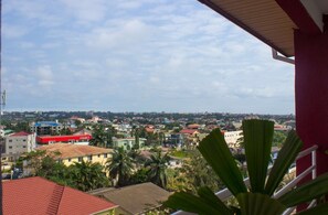 A view of a cityscape with buildings, including a red-roofed building labeled "E-PLAZA 2". - Earl Heights Suites Hotel (Accra)