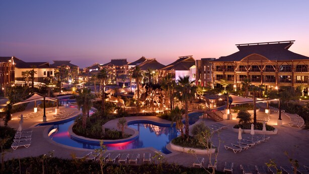A resort with a large pool, multiple buildings, and lounge areas. - Lapita, Dubai Parks and Resorts, Autograph Collection (Dubai)