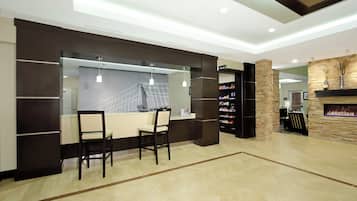 A modern kitchen with a dining area, built-in pantry, and a fireplace.