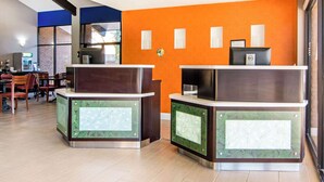 A reception area with two counters, a coffee machine, and a seating area with tables and chairs. - Quality Inn Toccoa (Toccoa)