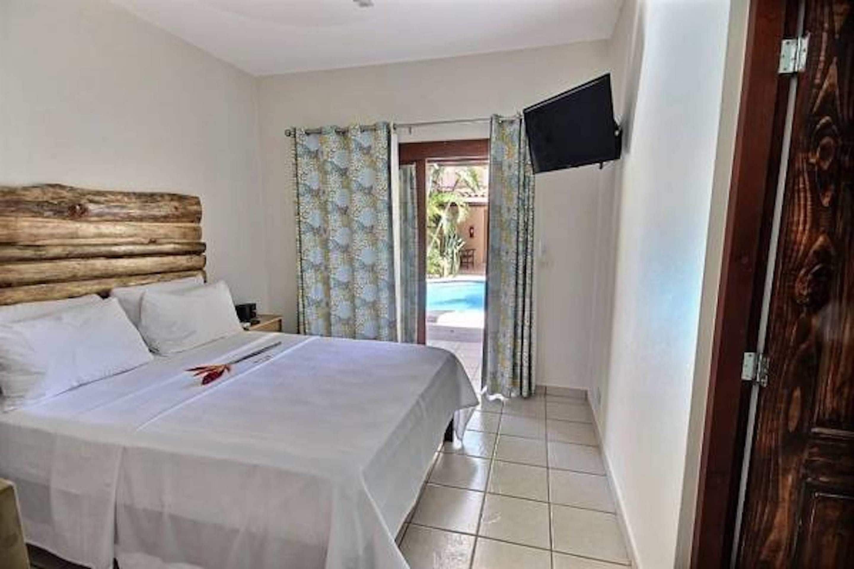 Poolside Quadruple Room | In-room safe, individually decorated, blackout drapes
