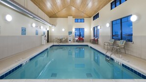 An indoor swimming pool with clear water, wooden ceiling, and multiple windows. - Best Western Plus Hudson Hotel & Suites (Hudson)