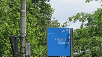 A blue sign with white text indicating the direction to Flagstaff Station.