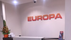 A reception desk with a sign that reads "EUROPA" above it.