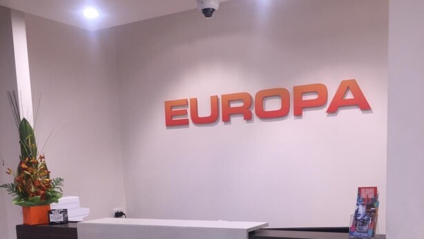 A reception desk with a sign that reads "EUROPA" above it. - Europa Melbourne - Hostel (Melbourne)