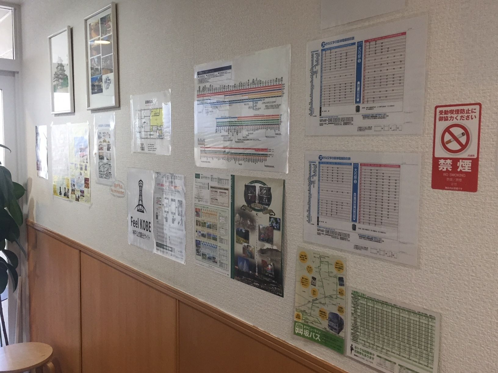 A wall with various informational posters, including maps and schedules.
