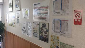 A wall with various informational posters, including maps and schedules.