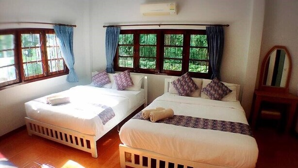 A room with two single beds, a mirror, and a window with curtains. - Hua Hin Home 66 Pool Villa (Hua Hin)