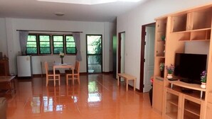 A spacious living area with a dining table, chairs, a bench, a TV stand, and a refrigerator. - Hua Hin Home 66 Pool Villa (Hua Hin)