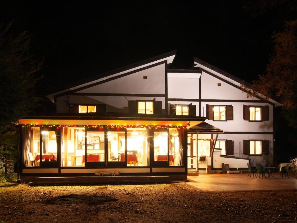 A two-story building with a covered front area, possibly a restaurant or cafe, and a visible outdoor seating area.